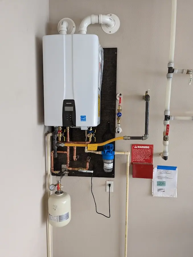 Professional plumber installing copper piping in a Lone Tree home